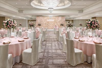 Celebrate your wedding at The Langham, Hong Kong with a romantic wedding venue accented with pink roses and satin panels.