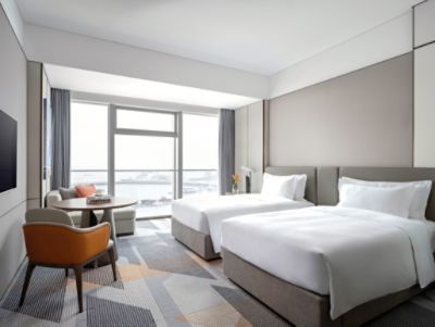 bedroom of deluxe hotel room twin bed