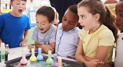 Children looking at beakers