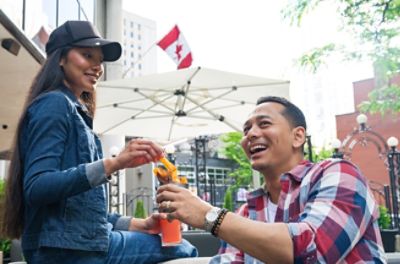 Two women having a drink at a sidewalk cafe