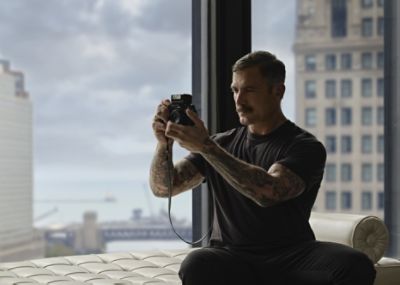 Douglas Friedman sitting in front of window
