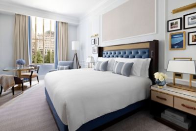 The Deluxe Room's spacious design incorporates elegant furnishing in blue and gold with maximal comfort.