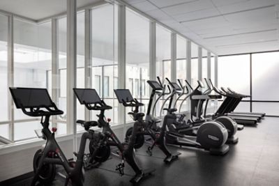 State-of-the-art fitness center at The Langham, Boston. Located on the fourth floor, the upper level of the fitness studio features peleton bikes, treadmills, and other cardio machines.