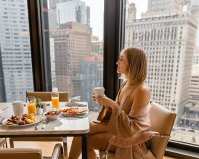 Woman eating breakfast at The Langham Club Lounge.