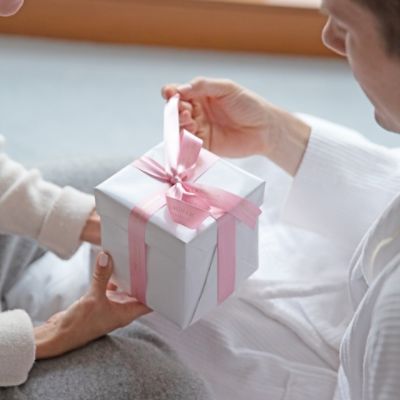 Two peopl exhcanging gifts from The Langham