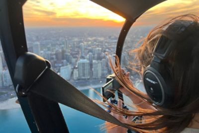 A woman on  a helicopter ride above Chicago