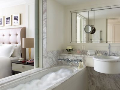 Soak in the bathtub in the elegant marble bathroom with a large glass bathroom window at our Executive Rooms.
