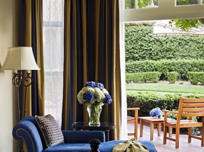 The Langham Huntington, Pasadena Deluxe Patio Room is highlighted by floor-to-ceiling doors which open up to a patio.