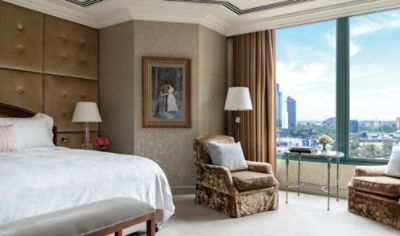 Experience the height of luxury in the Chairman Suite, the bedroom is  designed  with large windows and cityscape views.